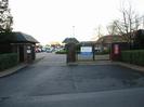 The main entrance of the Bishop Centre.
Metal gates between high brick pillars.
Cars in car-park beyond gates.
Buildings with low partial-pitch roofs.
TO LET sign on gate.