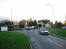 Junction of Hitcham Road, Hag Hill Lane, and the A4 Bath Road.
Wide grass verges on both sides.
Large white house seen across junction.
Cars on road.
